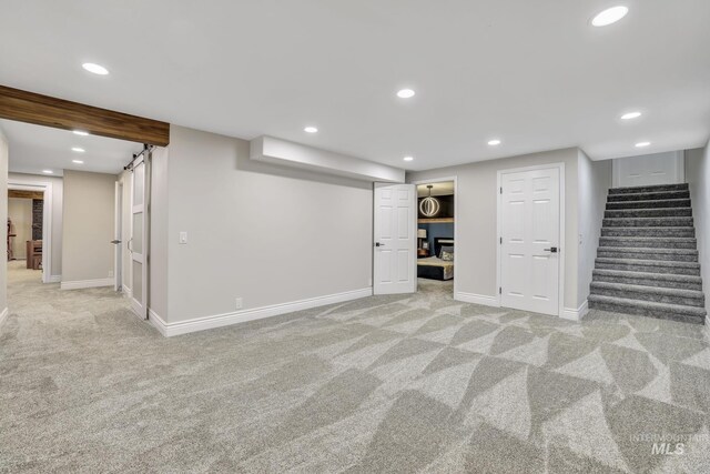 930 W Wanda Ln, Heyburn, ID 83336 - finished below grade area with light carpet, stairway, baseboards, and recessed lighting