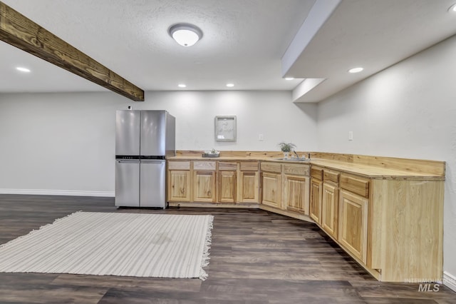 930 W Wanda Ln, Heyburn, ID 83336 - kitchen with freestanding refrigerator, light brown cabinetry, dark wood-type flooring, beamed ceiling, and baseboards