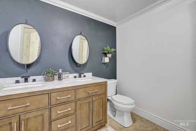930 W Wanda Ln, Heyburn, ID 83336 - bathroom featuring toilet, ornamental molding, double vanity, tile patterned flooring, and baseboards