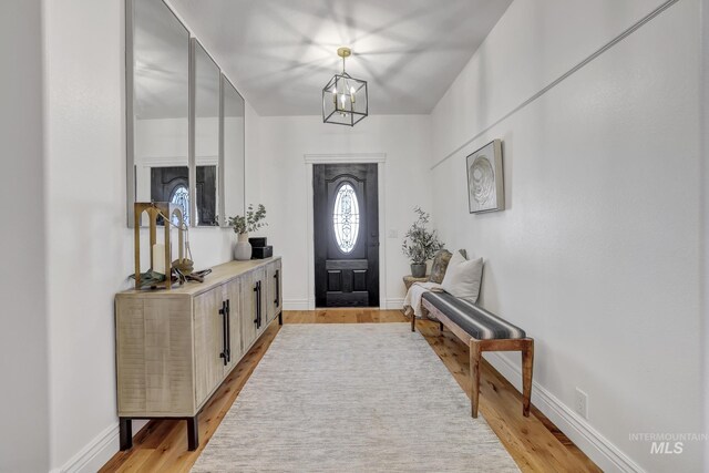 930 W Wanda Ln, Heyburn, ID 83336 - entryway featuring light wood finished floors, a chandelier, and baseboards