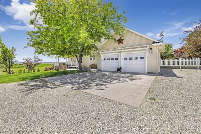 930 W Wanda Ln, Heyburn, ID 83336 - view of front of house with driveway, fence, a garage, and covered porch