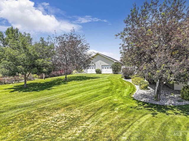 930 W Wanda Ln, Heyburn, ID 83336 - view of grassy yard featuring an attached garage