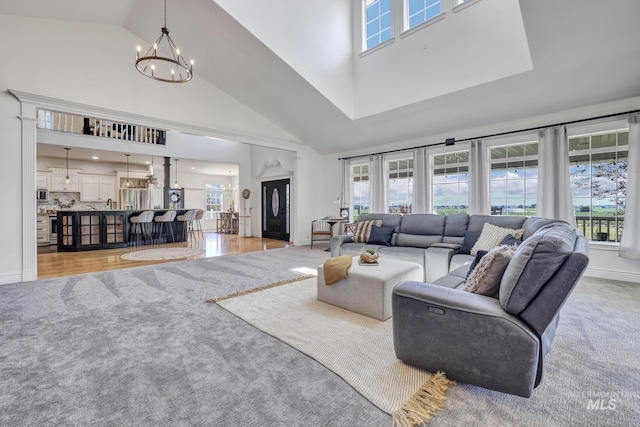 930 W Wanda Ln, Heyburn, ID 83336 - living room featuring high vaulted ceiling, a chandelier, healthy amount of natural light, and baseboards