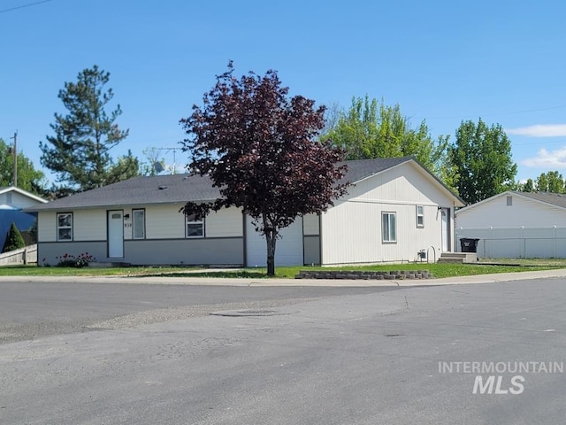 single story home featuring fence