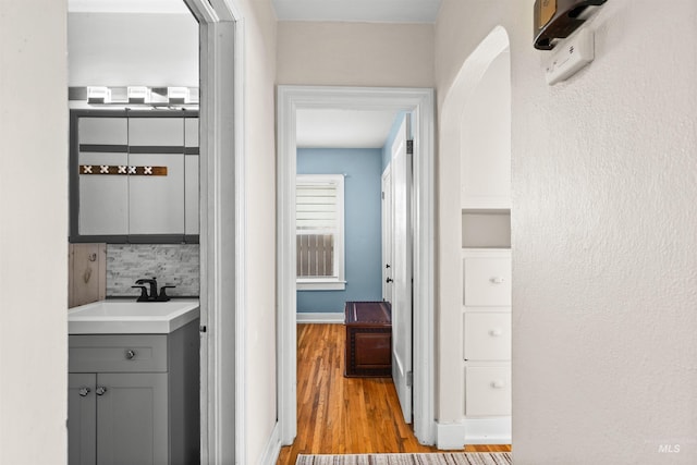 hallway featuring sink and light hardwood / wood-style floors