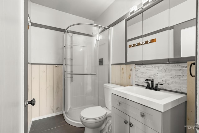 bathroom with vanity, decorative backsplash, toilet, and walk in shower