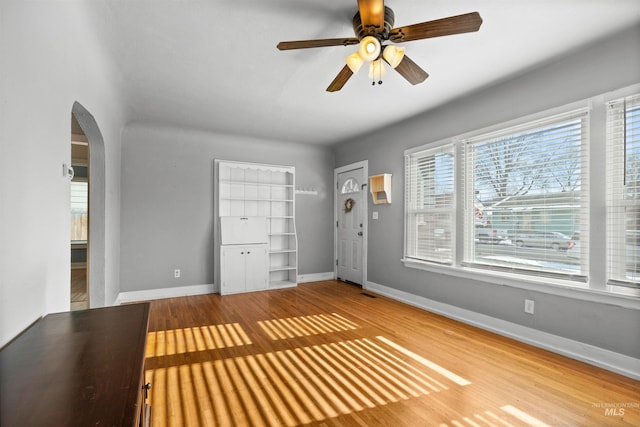 foyer with hardwood / wood-style flooring and ceiling fan