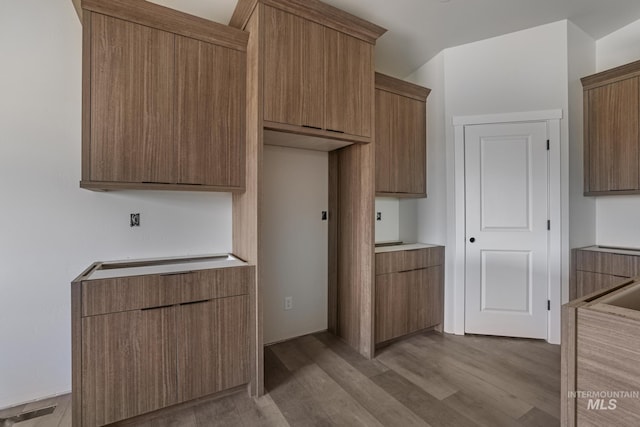 916 23rd Ave E, Jerome, ID 83328 - kitchen with light countertops, wood finished floors, and brown cabinets