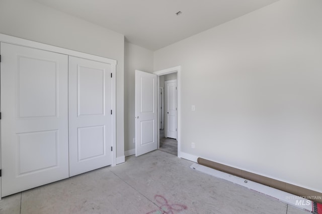 916 23rd Ave E, Jerome, ID 83328 - unfurnished bedroom featuring concrete flooring, baseboards, and a closet