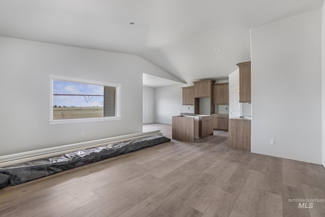 916 23rd Ave E, Jerome, ID 83328 - unfurnished living room with lofted ceiling and light wood-style floors
