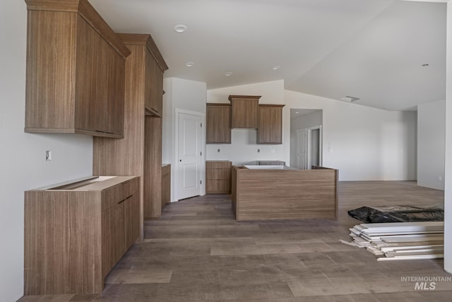 916 23rd Ave E, Jerome, ID 83328 - kitchen with lofted ceiling, brown cabinetry, visible vents, and dark wood-style flooring