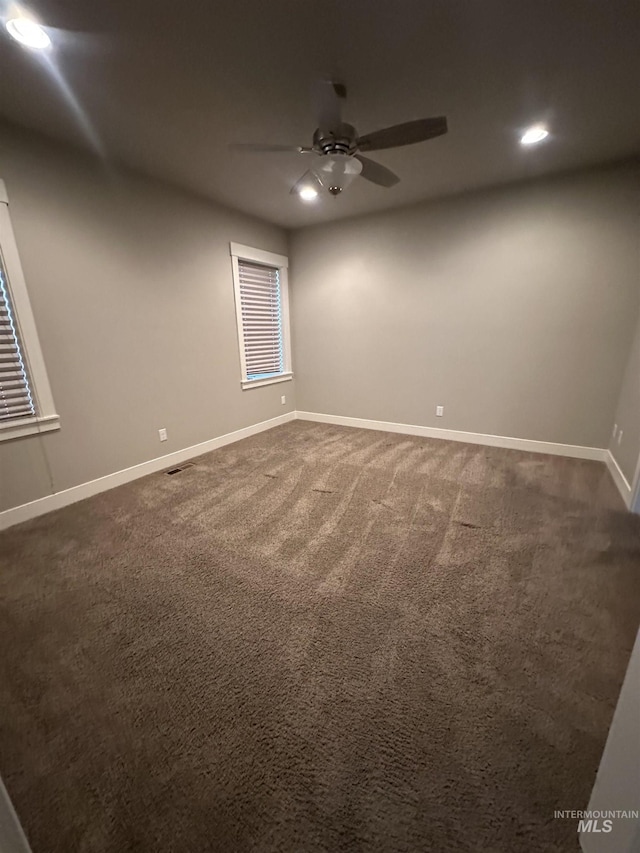 unfurnished room with a ceiling fan, recessed lighting, baseboards, and dark carpet