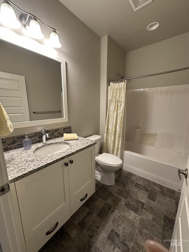bathroom featuring toilet, shower / tub combo with curtain, and vanity