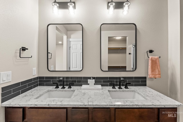 full bath featuring double vanity and a sink