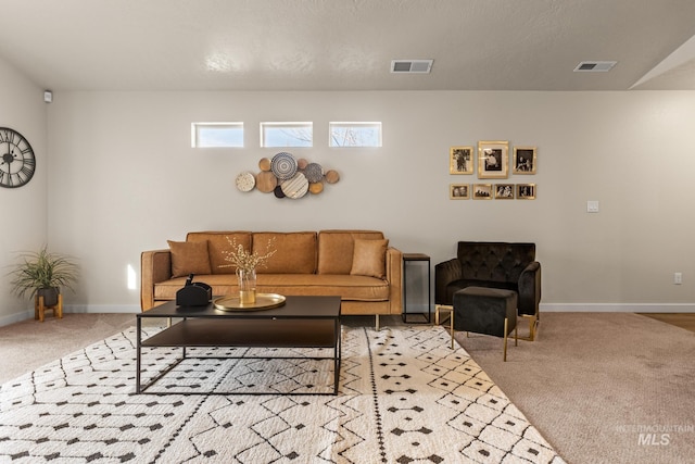 carpeted living area with visible vents and baseboards