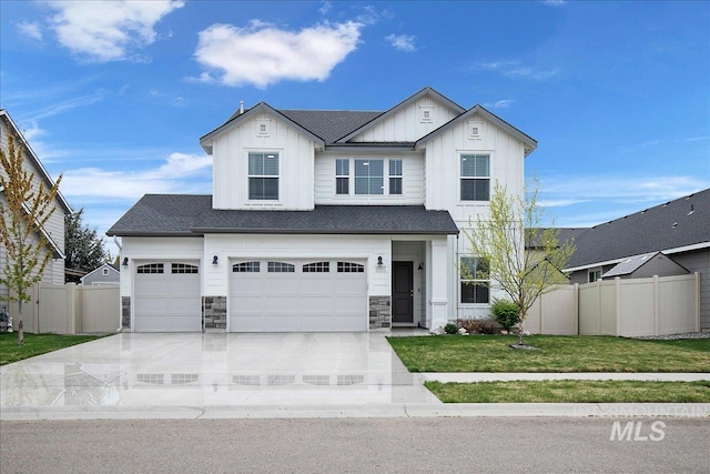 view of front of house featuring driveway, board and batten siding, an attached garage, fence, and a front lawn