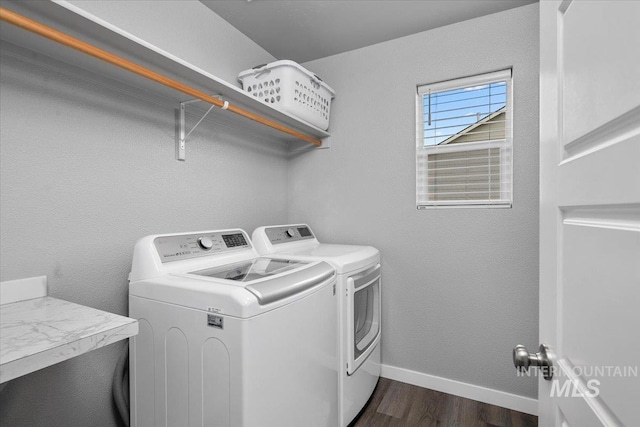 laundry room featuring washing machine and dryer, dark wood-style flooring, laundry area, and baseboards
