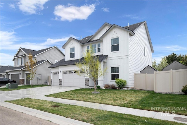 traditional home featuring board and batten siding, fence, a garage, driveway, and a front lawn