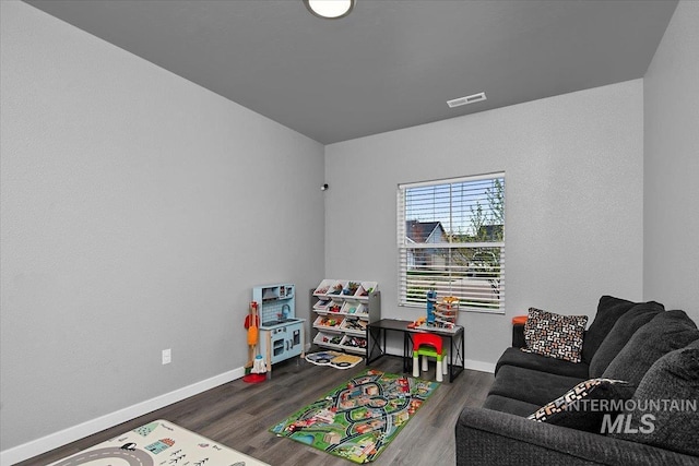 game room with visible vents, wood finished floors, and baseboards