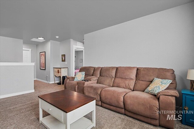 living area featuring baseboards and carpet flooring