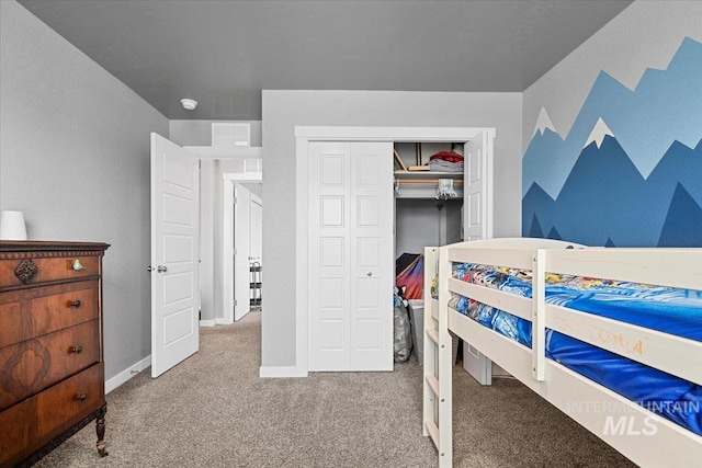 bedroom with a closet, carpet floors, and baseboards