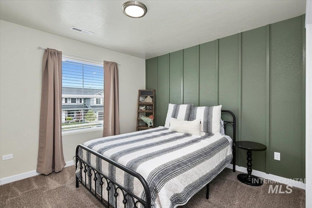bedroom with visible vents, carpet flooring, and baseboards