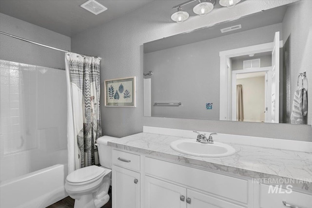 bathroom featuring visible vents, toilet, shower / bath combination with curtain, and vanity
