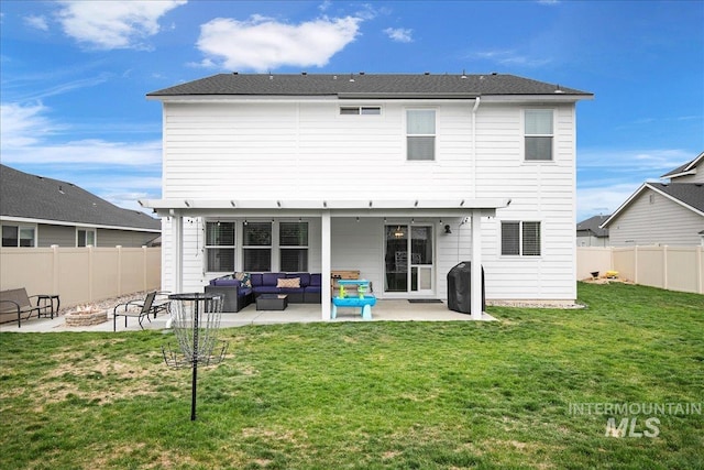 rear view of house featuring a lawn, a fenced backyard, an outdoor living space with a fire pit, and a patio area
