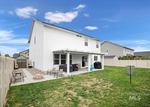 rear view of property featuring a patio area, a yard, a fenced backyard, a shed, and an outdoor living space with a fire pit