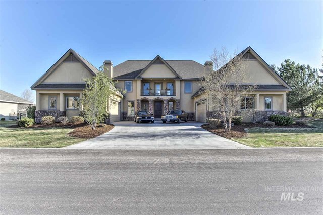 view of front of property featuring stucco siding, a front yard, driveway, and a chimney