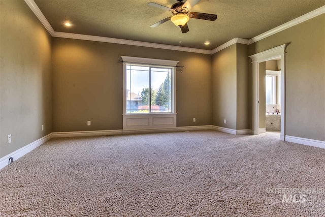 carpeted spare room featuring a textured ceiling, baseboards, crown molding, and a ceiling fan