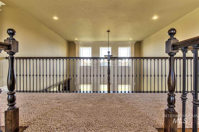 hallway featuring recessed lighting and a textured ceiling