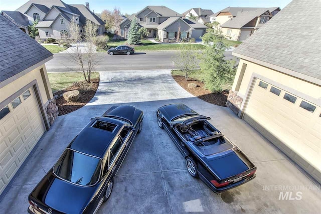 view of street featuring a residential view and concrete driveway