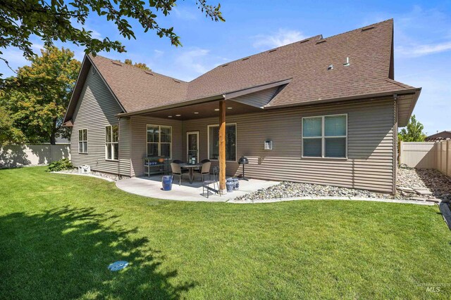 455 Coiner Cir, Twin Falls, ID 83301 - rear view of house with roof with shingles, a fenced backyard, and a patio area