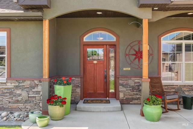 455 Coiner Cir, Twin Falls, ID 83301 - view of exterior entry with stone siding, stucco siding, and a porch