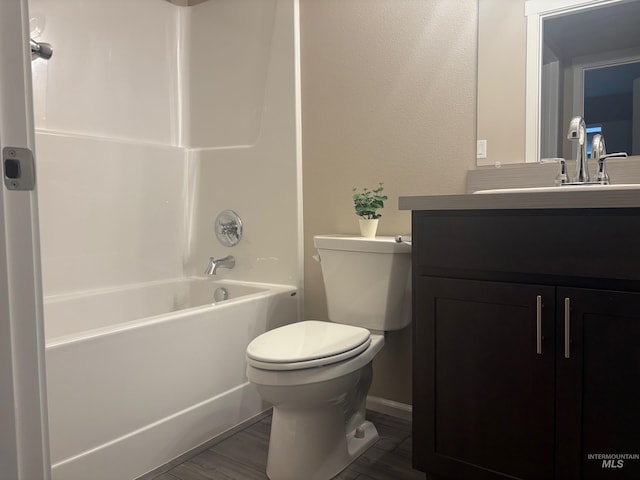 full bathroom featuring shower / bathtub combination, hardwood / wood-style floors, vanity, and toilet