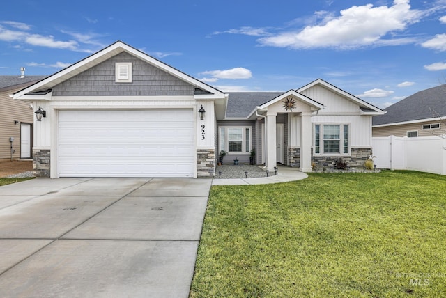 view of front of property featuring a front lawn and a garage