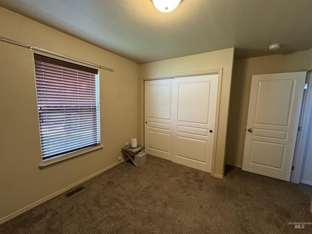 1309 Golden Pheasant Dr, Twin Falls, ID 83301 - unfurnished bedroom featuring a closet, dark colored carpet, and baseboards
