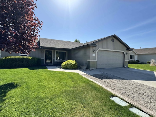 1309 Golden Pheasant Dr, Twin Falls, ID 83301 - ranch-style home featuring an attached garage, driveway, a front lawn, and roof with shingles