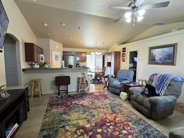 1309 Golden Pheasant Dr, Twin Falls, ID 83301 - living room with lofted ceiling, ceiling fan, light wood-type flooring, a chandelier, and arched walkways