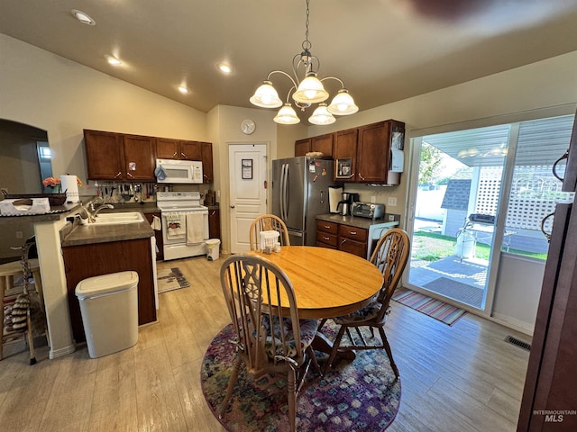 1309 Golden Pheasant Dr, Twin Falls, ID 83301 - dining room featuring a chandelier, lofted ceiling, light wood finished floors, and recessed lighting