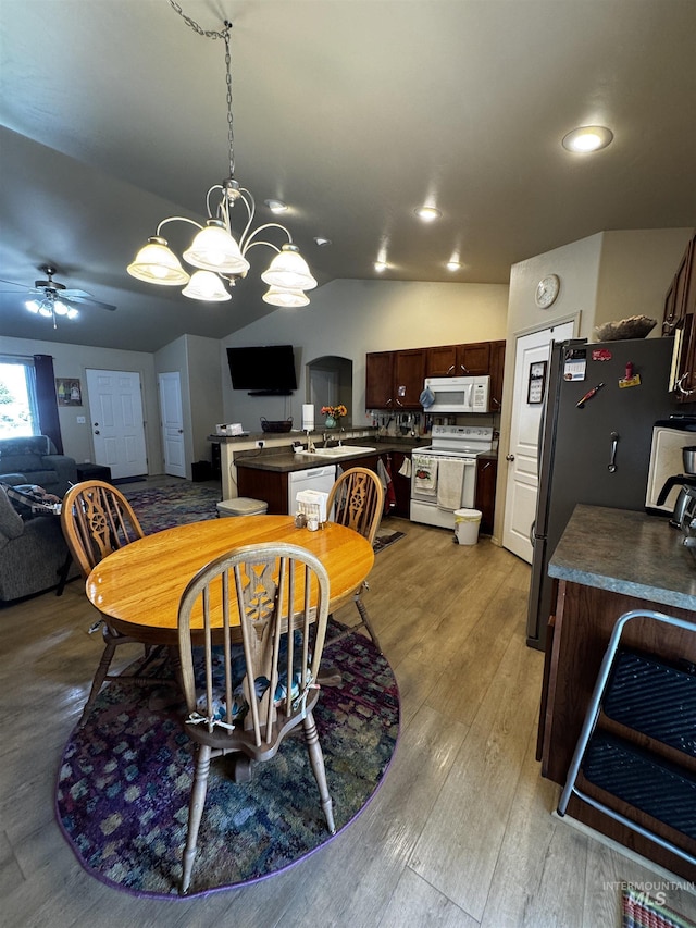 1309 Golden Pheasant Dr, Twin Falls, ID 83301 - dining room with ceiling fan, a chandelier, light wood-style floors, and lofted ceiling