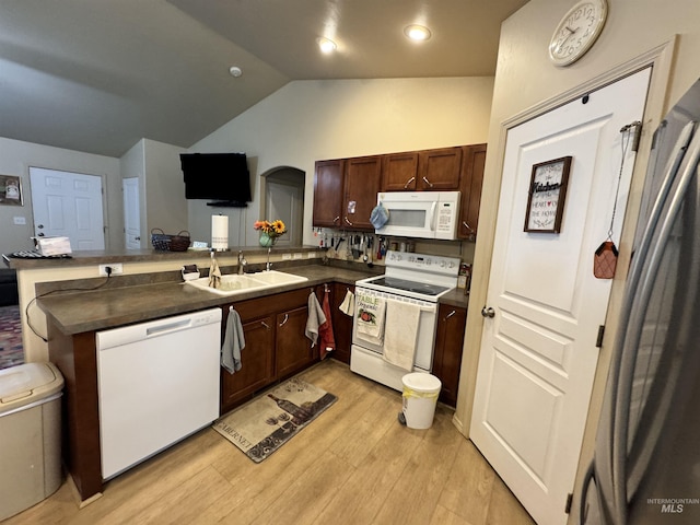 1309 Golden Pheasant Dr, Twin Falls, ID 83301 - kitchen with white appliances, a sink, a peninsula, dark countertops, and vaulted ceiling