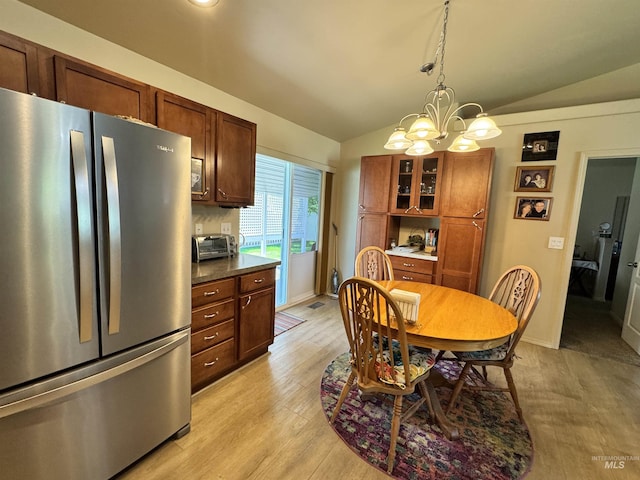1309 Golden Pheasant Dr, Twin Falls, ID 83301 - dining space featuring lofted ceiling, a chandelier, light wood-type flooring, and baseboards