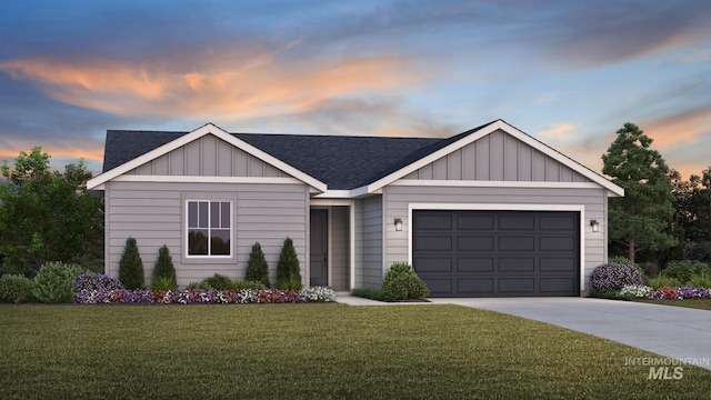 view of front of property featuring a garage and a lawn