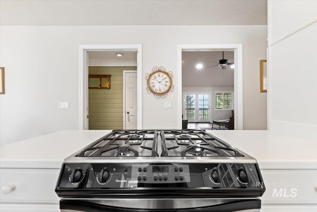 kitchen featuring a ceiling fan, light countertops, and black range with gas cooktop