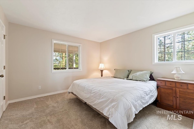 carpeted bedroom with baseboards