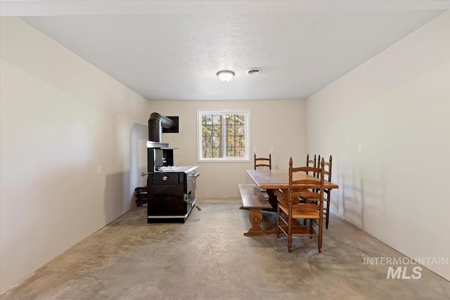 dining area featuring concrete flooring and visible vents