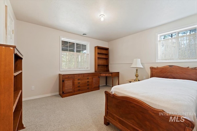 bedroom featuring baseboards and carpet flooring