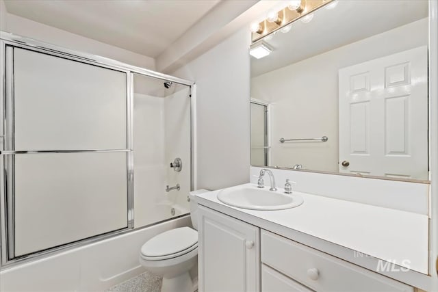 full bathroom featuring combined bath / shower with glass door, toilet, and vanity